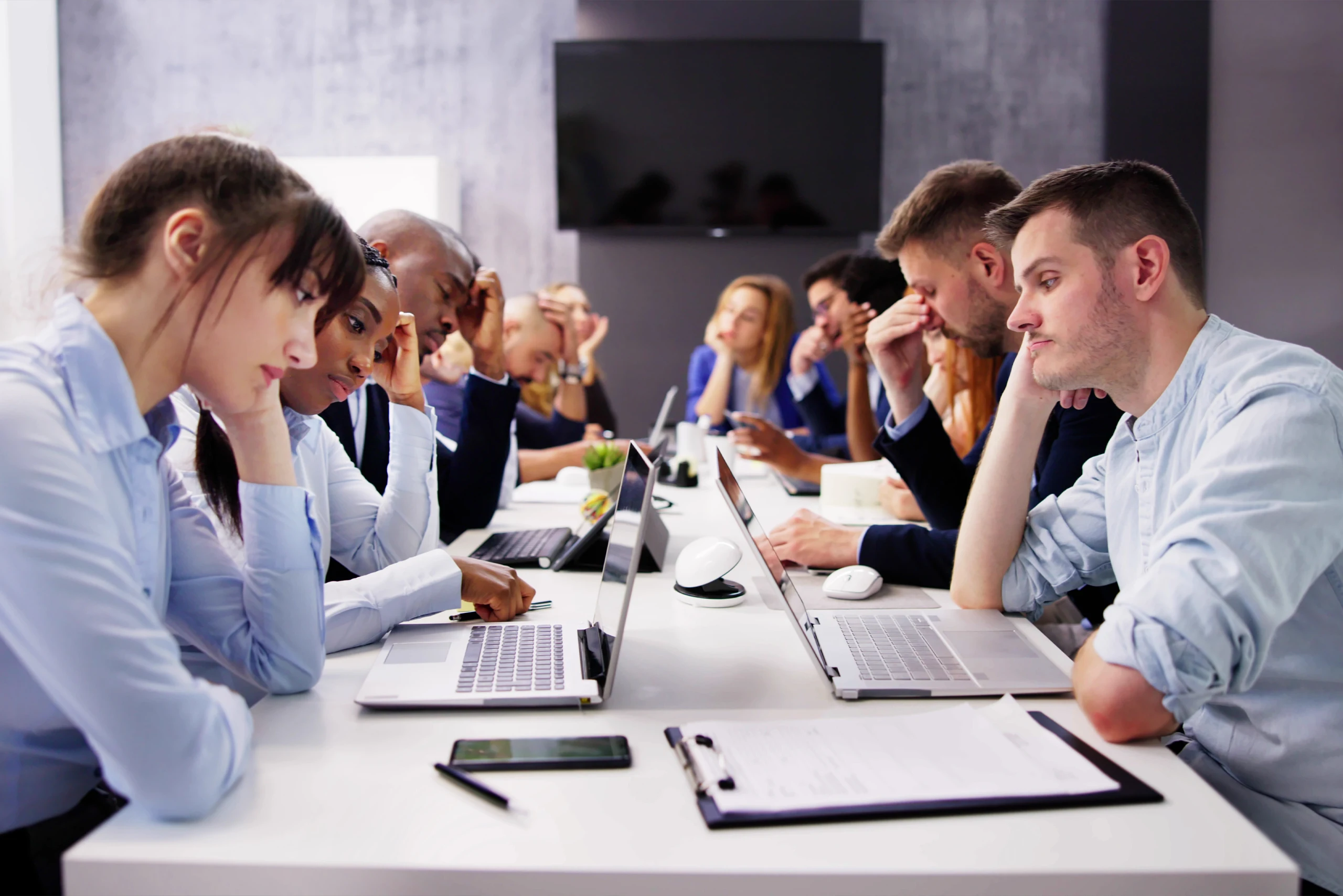 A room full of burned out employees that look depressed and unproductive